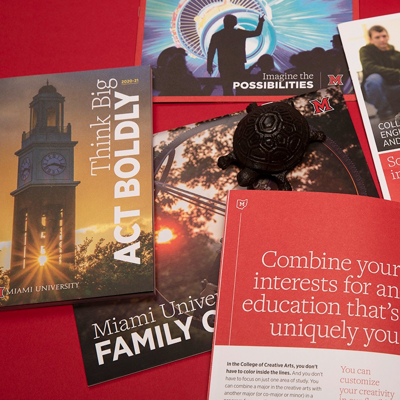 A selection of printed brochures using the Miami brand with headlines: Think Big Act Boldly; Miami University Family; and Combine Your Interests for an Education that is Uniquely You
