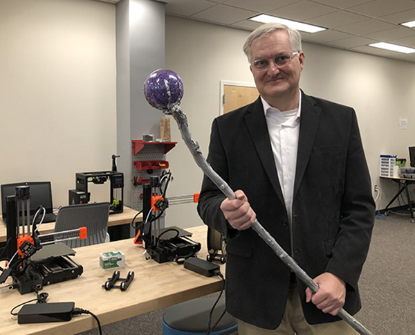 Mark Dalquist holds 3_D replica of Prospero's staff