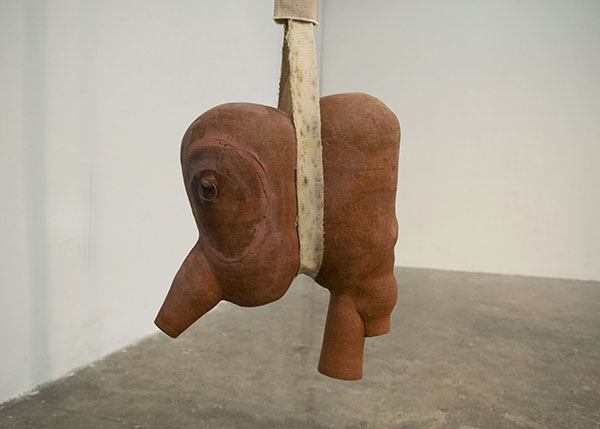 Aida Lizalde's sculpture Reciprocation/Morbid relief,  high-fired ceramic, raw clay, cotton, retired fire hose, hardware