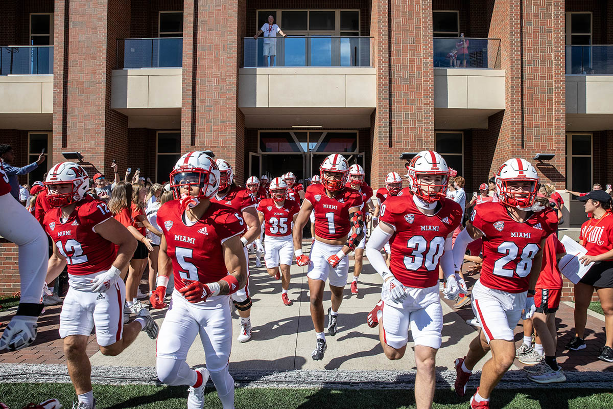 Miami football team runs on the field