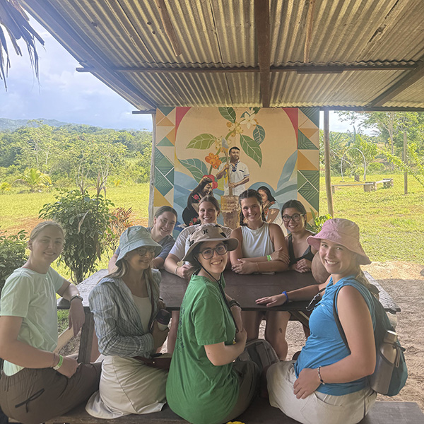 Molly Phelan and friends are ready to enjoy a freshly brewed cup of coffee made with shade-grown beans in the foothills of the Maya Mountains at Oxmul Coffee, a family-run farm in the village of San Antonio, Belize (photo courtesy of Erin Wahler).