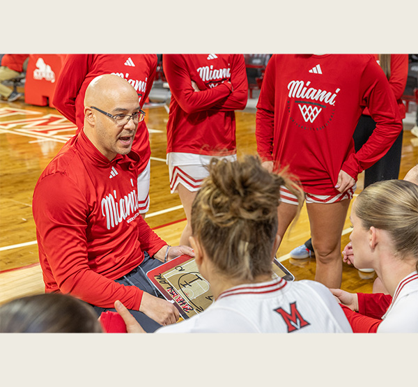 Coach Glenn Box talks to his team during a break in the action (photo by Scott Kissell).