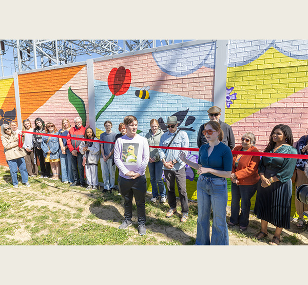 Miami students stand in front of the mural they painted at the corner of Spring and Locust streets in Oxford.